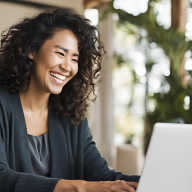 Smiling woman on a laptop ready to assist visitors with questions or style tips.